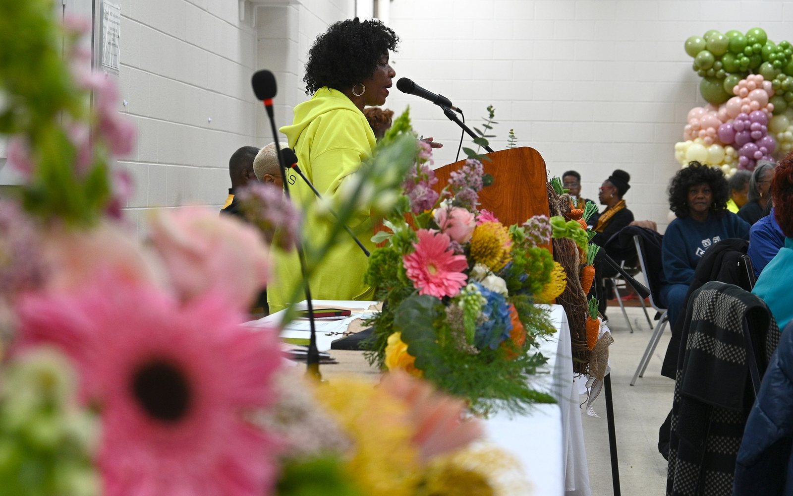 Golden Opportunity Club leadership speaking at a podium